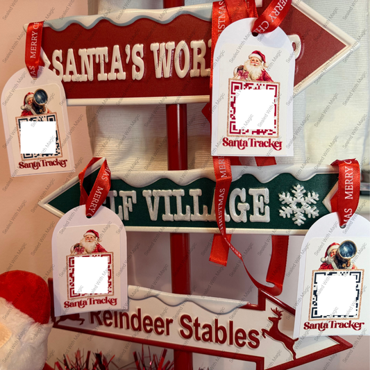 Decorative sign with 'Santa's Workshop' and 'Reindeer Stables' text, featuring Santa Tracker tags.