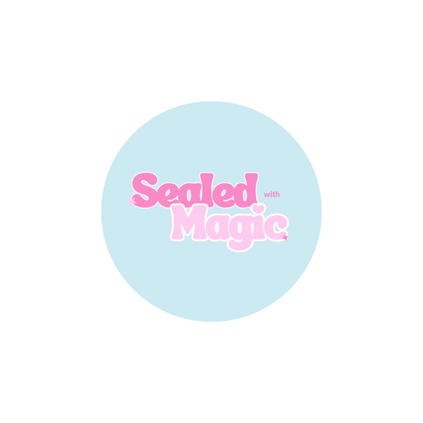 Round blue sticker with 'Sealed with Magic' text in pink on a white background